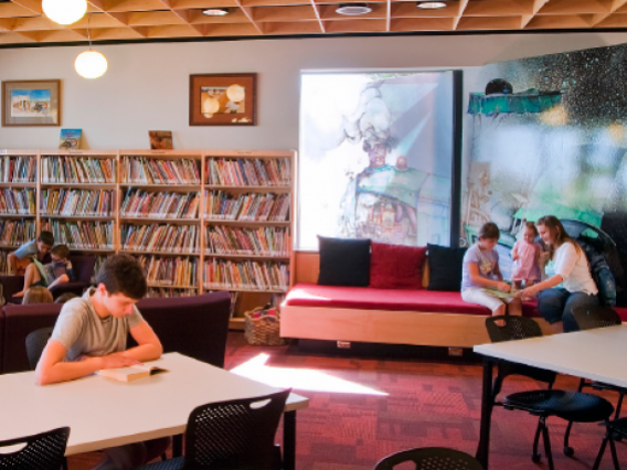 inside view of WOW library, adults and family sitting at tables