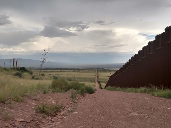 desert scene with border wall