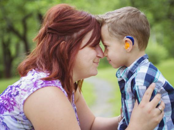 women with little boy in hearing aids