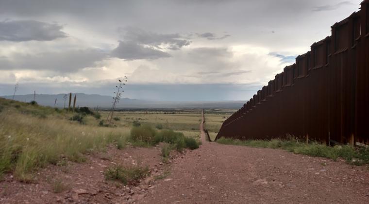 desert scene with border wall