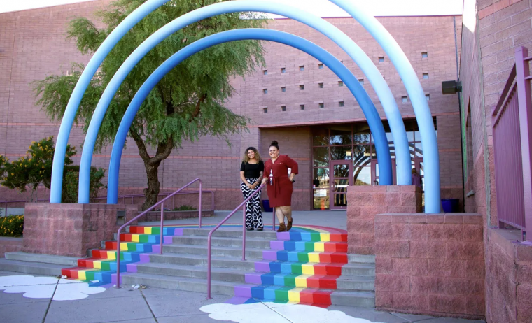 educators standing on school steps