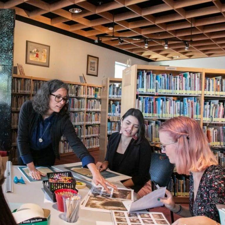Rebecca Ballenger works with her students to prepare books for their silent books exhibit