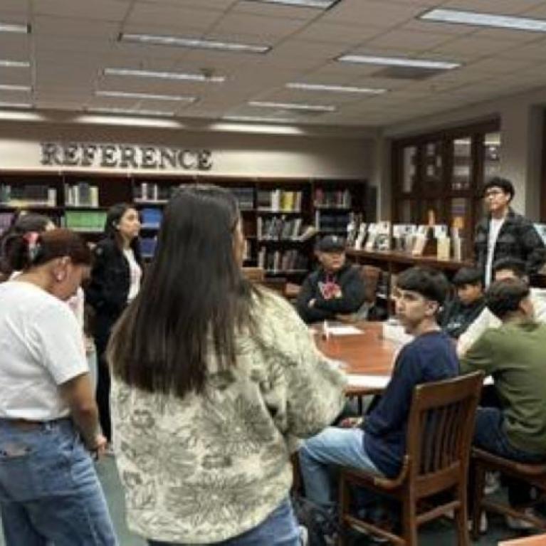 group of students and educators gathered in a library