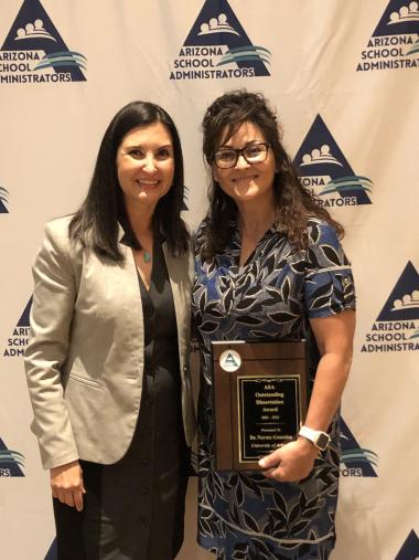 Dr. Norma González (right) receives the Arizona School Administrators Dissertation Award from the organization’s past president, Dr. Lupita Hightower (left).